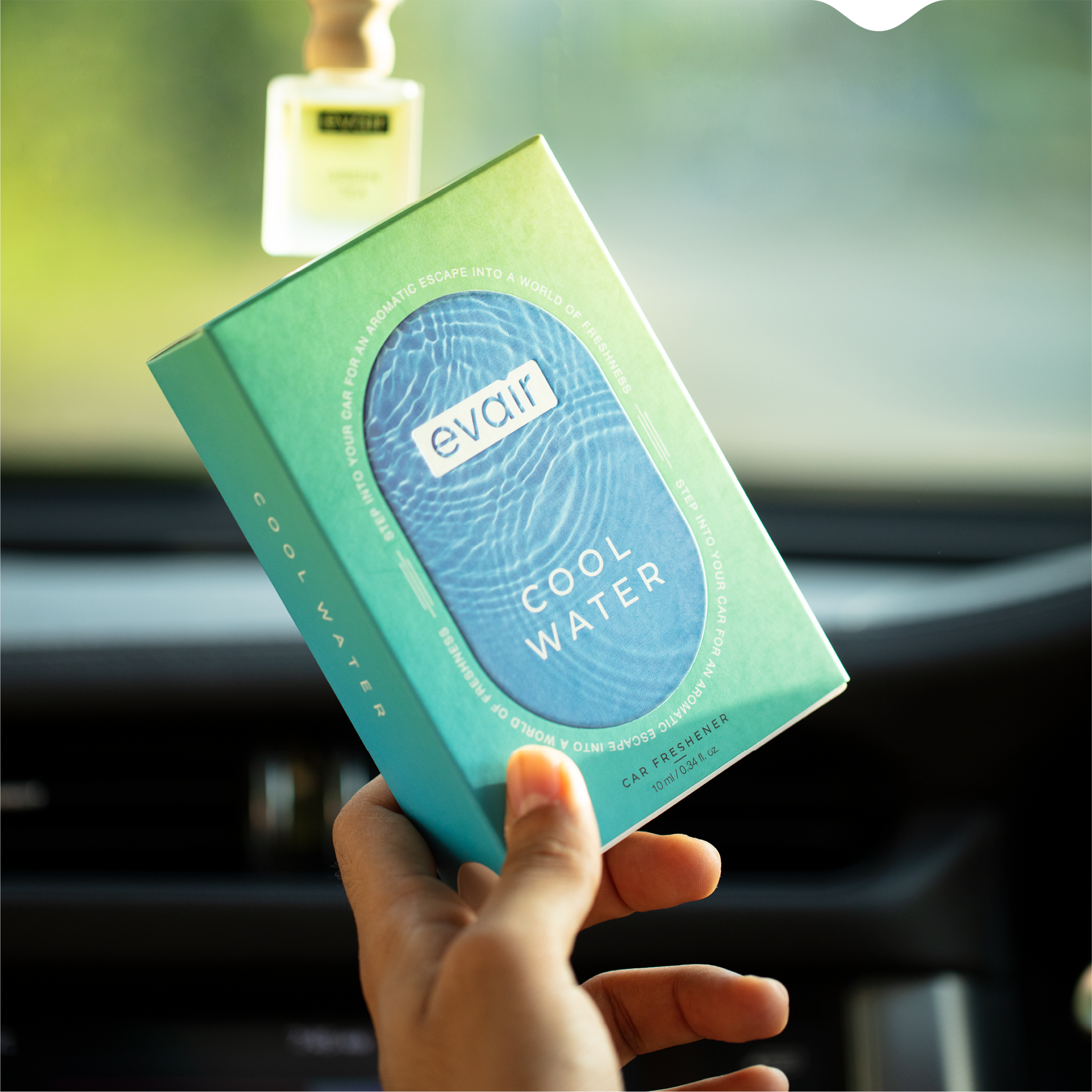Men Holding Evair Cool Water Long lasting Car Perfume in car with Hanging Evair Car Air Freshener