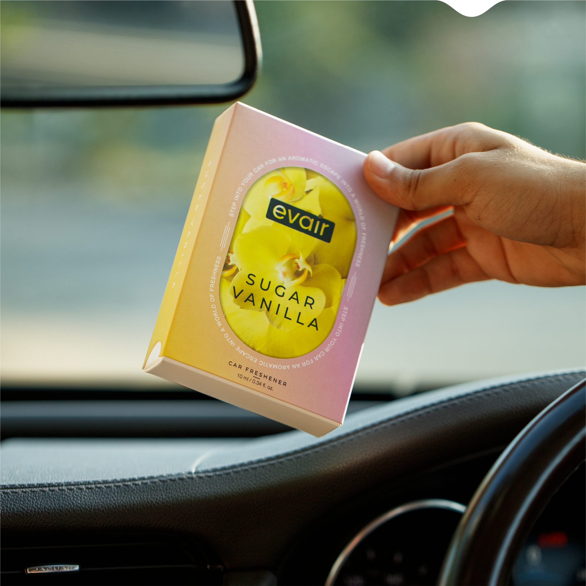 Men Holding Evair Vanilla Long lasting Car Perfume in car